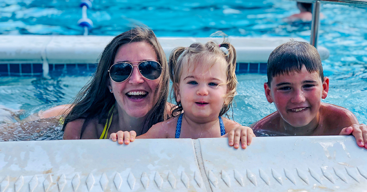 Myra, Capital One part-time associate, plays in the pool with her two children